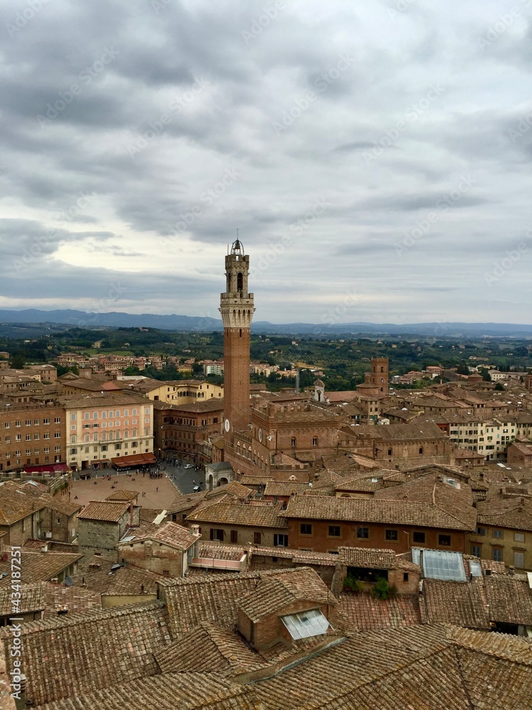 SIENA, ITALY. Panorama view of Siena from Cathedral. Evening, cloudy sky, Tuscany hills on a background, tile rooftop, medieval town. Date of photo is 28.09.2015