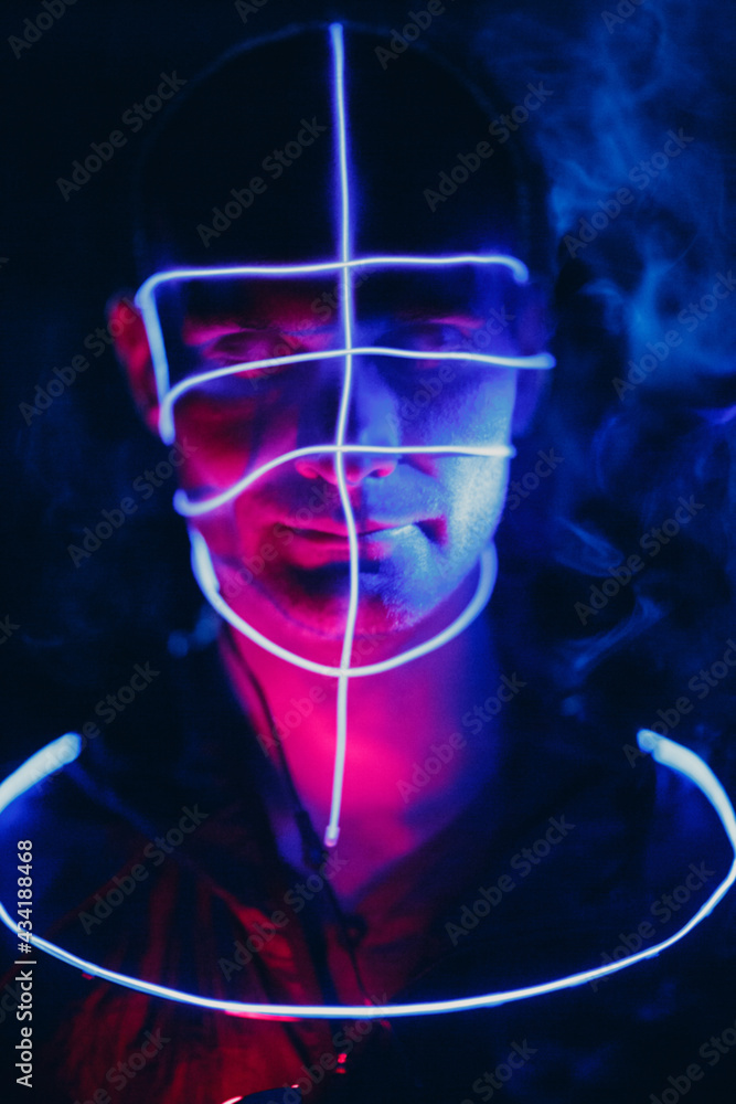 Portrait of man with neon glow lines on his face. Concept cyberpunk Portrait of man with neon glow lines on his face. Concept cyberpunk