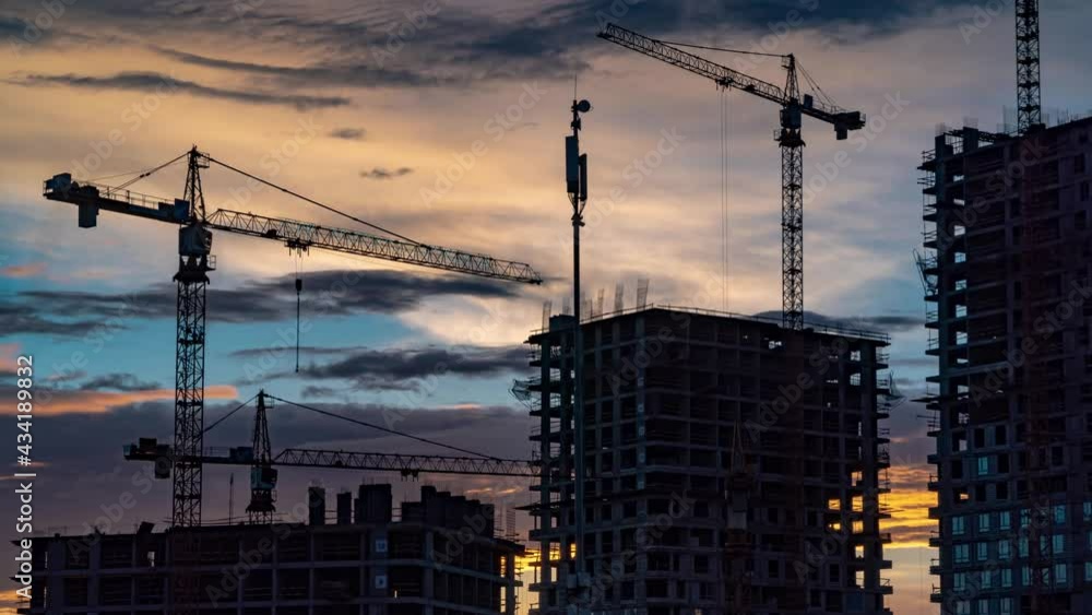 Cranes working day and night on construction of the housing estate in former industrial zone, time lapse Cranes working day and night on construction of the housing estate in former industrial zone, time lapse