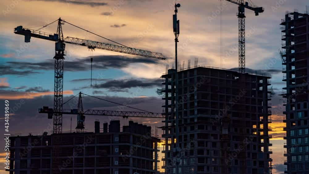 Cranes working day and night on construction of the housing estate in former industrial zone, time lapse Cranes working day and night on construction of the housing estate in former industrial zone, time lapse