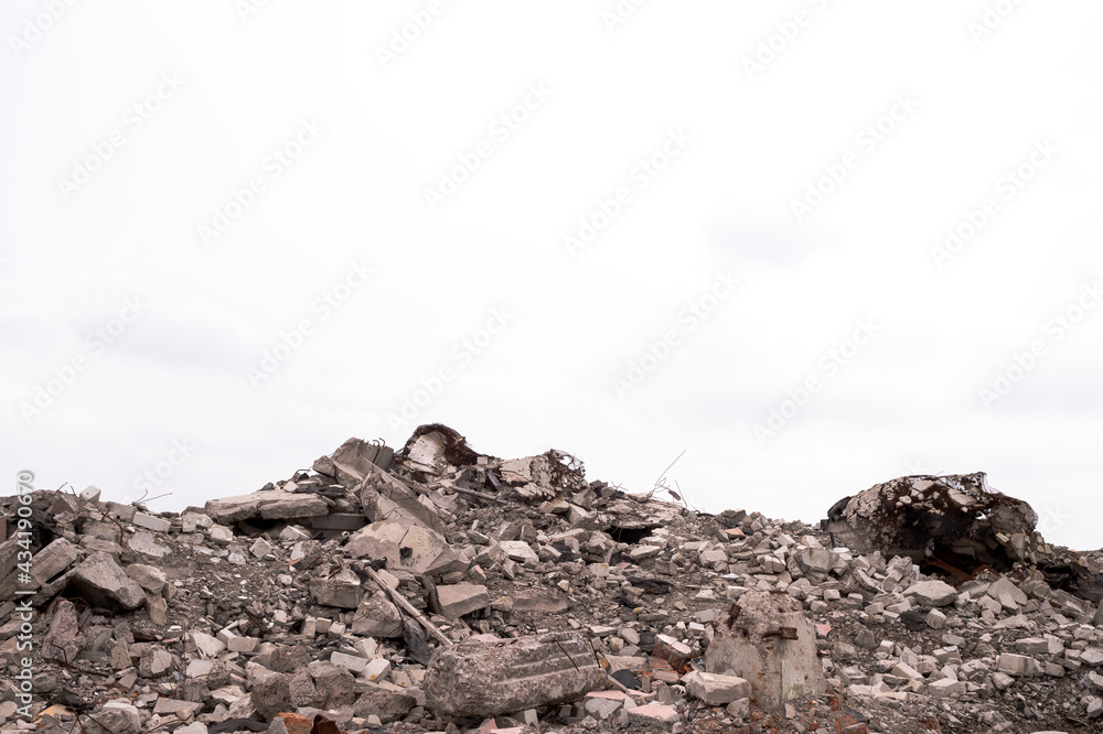A pile of construction debris against a gray sky. Background