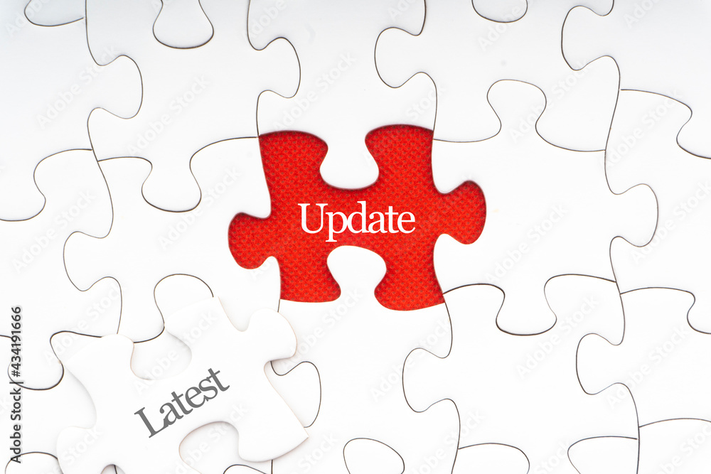 LATEST UPDATE text with jigsaw puzzle on red background. Business and Motivation Concept LATEST UPDATE text with jigsaw puzzle on red background. Business and Motivation Concept