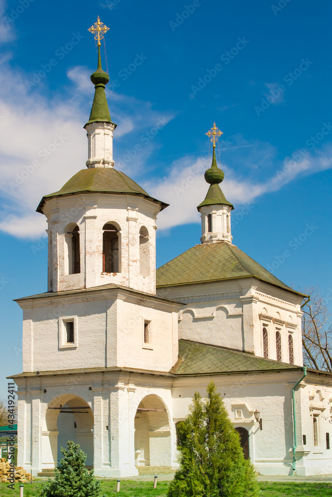 An old church.The green dome of the church with a cross on the background of the blue sky. Cross on the dome of the Orthodox church.