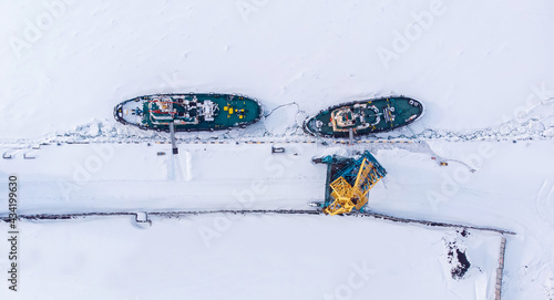 Bild auf Leinwand Ice bound ships froze in snow in winter, waiting for breaker, aerial top view
