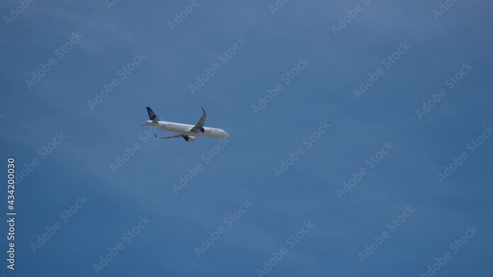 Passenger airliner aircraft plane flying in the sky. Tourist air transportation Passenger airliner aircraft plane flying in the sky. Tourist air transportation