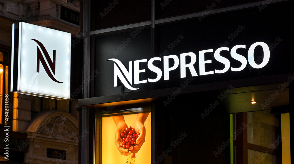 Vienna, Austria - November Illuminated sign on the outside of a branch of  the Nespresso coffee company at night in Vienna city centre. the company  sells coffee capsules and coffee machines. Stock