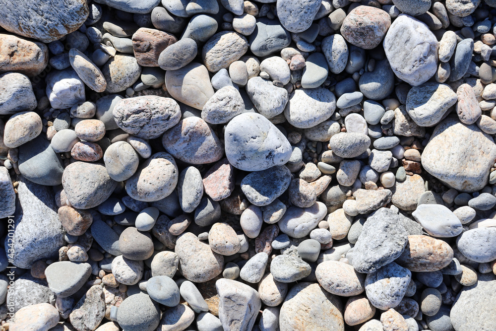 Smooth, weathered and sun-bleached rocks on the beach Smooth, weathered and sun-bleached rocks on the beach