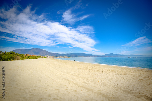 Beach beautiful sunny day sand sea ocean sky mountain manilva estepona photo