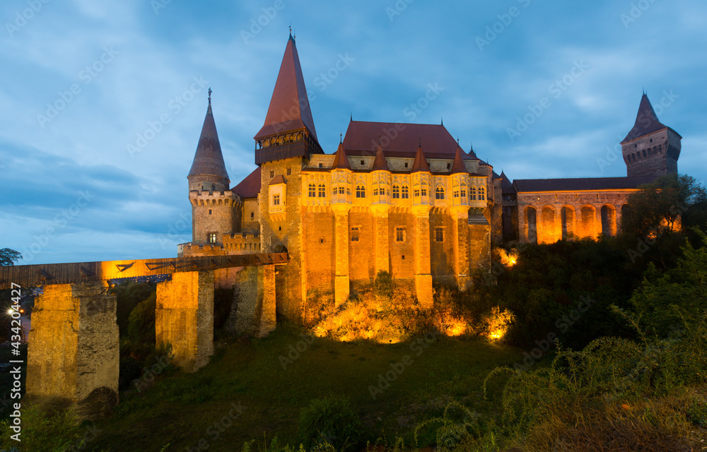 View of illuminated Gothic-Renaissance Corvin Castle in night, Hunedoara, Romania