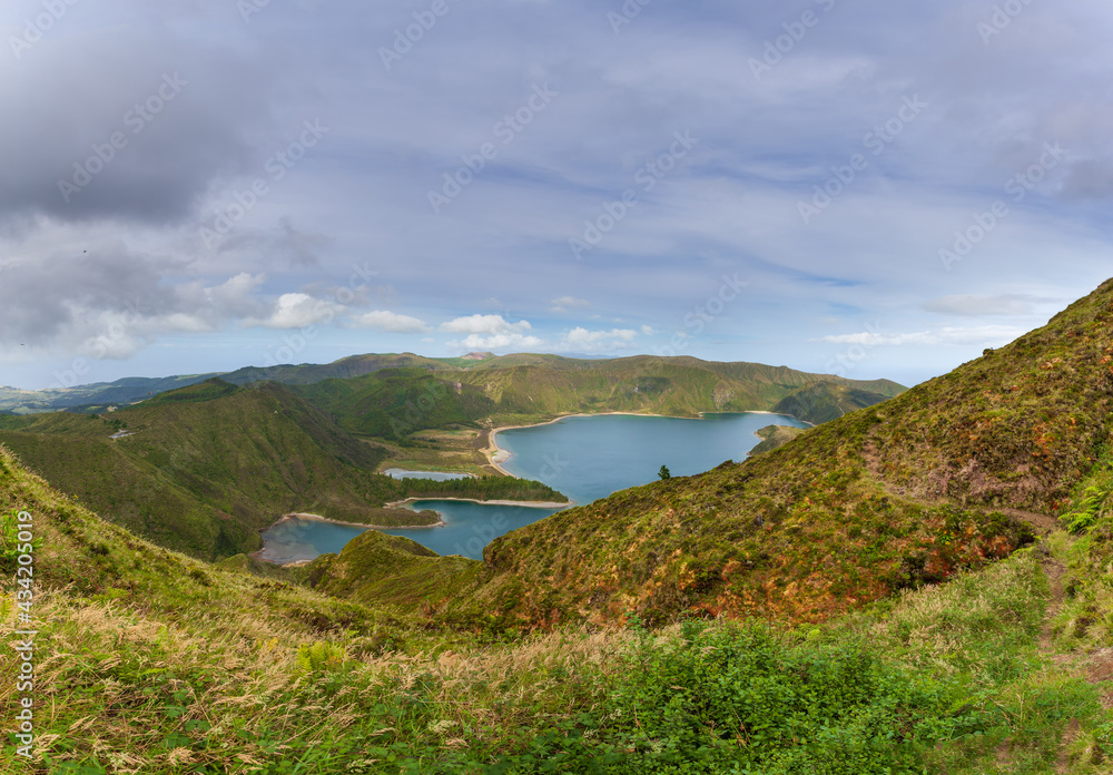 Azores, Portugal. Beautiful lagoon on the island of São Miguel, travel destination. Breathtaking natural landscape in the background. Lagoon in the crater of a volcano.