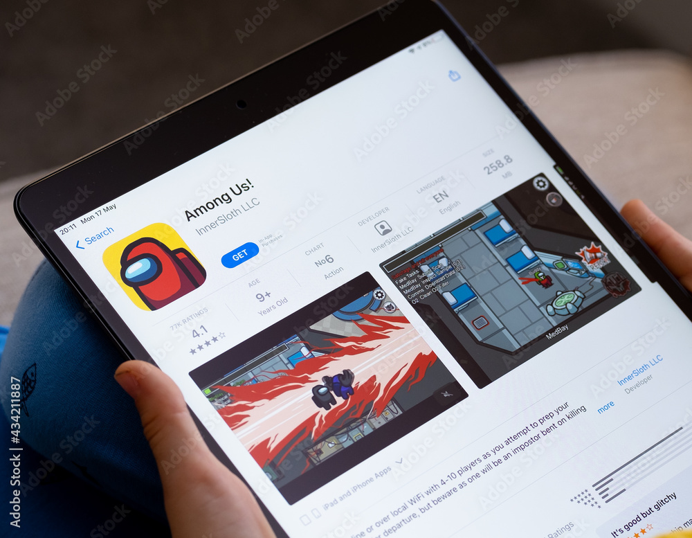 Among Us game app seen on the screen of ipad which is in the hands of