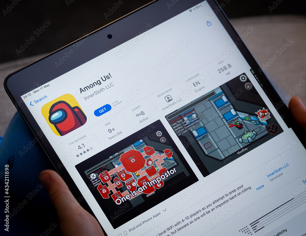 Among US game app seen on the screen of ipad which is in the hands of