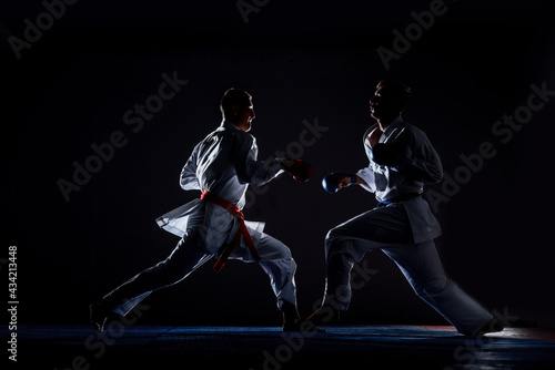 Young man is practicing martial arts in sport gym © qunica.com