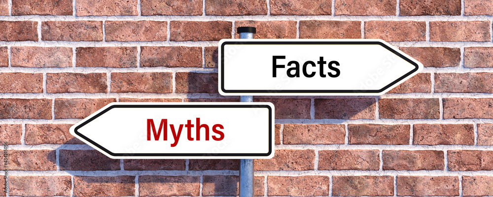 road signs with message MYTHS and FACTS showing the direction in front of a brick wall background road signs with message MYTHS and FACTS showing the direction in front of a brick wall background