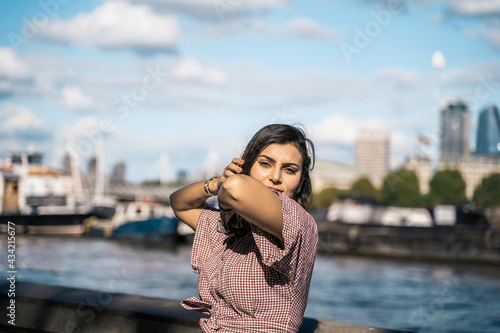 Portrait of a beautiful young woman outdoors in the city. Urban landscape. Travel and freelance lifestyle. Youth and beauty © algrigo