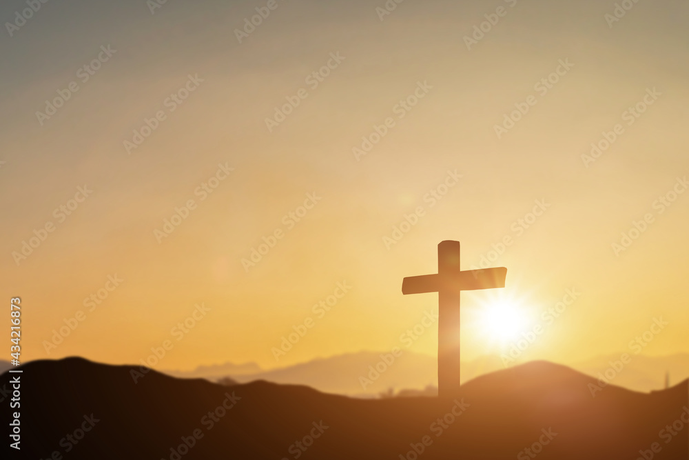 Crucifixion of jesus christ, catholic cross at sunset background. Resurrection concept