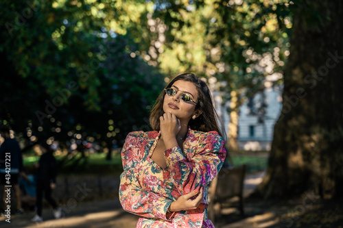 Portrait of a beautiful young woman outdoors in the city. Urban landscape. Travel and freelance lifestyle. Youth and beauty