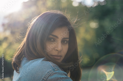 Portrait of a beautiful young woman outdoors in the city. Urban landscape. Travel and freelance lifestyle. Youth and beauty