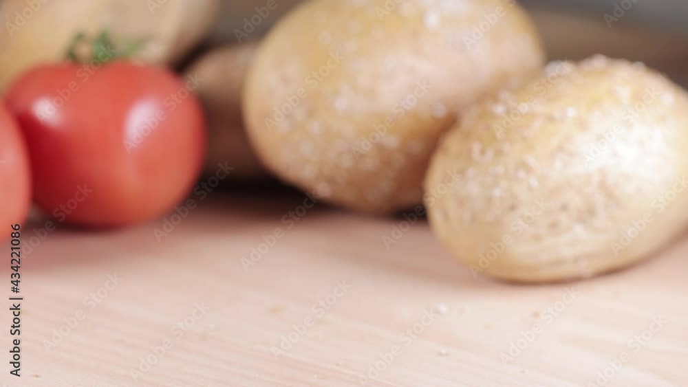 Preparing sandwich on breakfast table full of vegtables. Preparing sandwich on breakfast table full of vegtables.