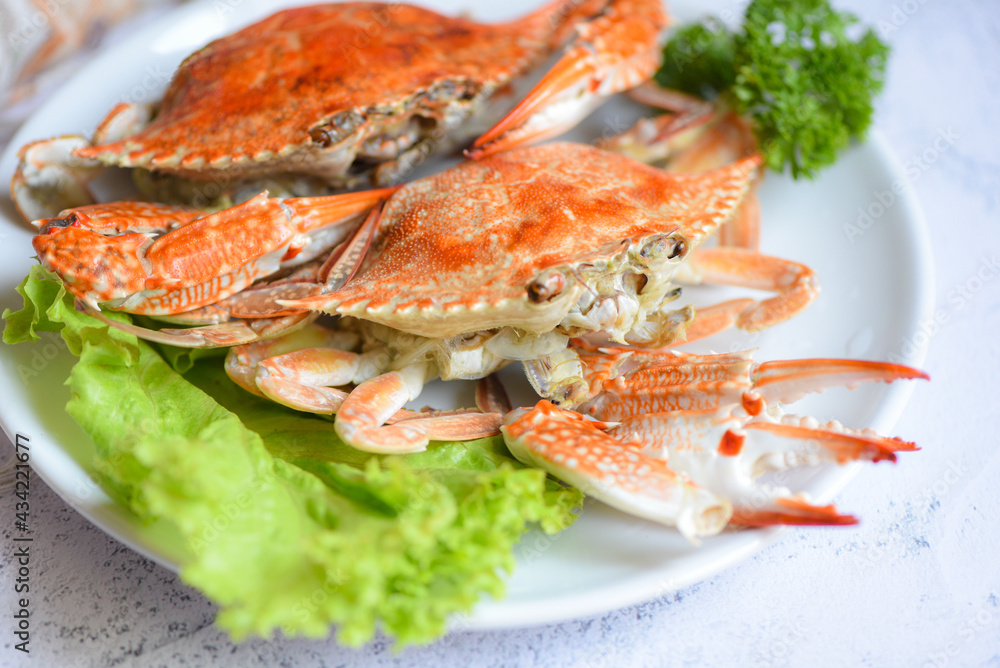Steamed or boiled Blue Swimming Crab ocean gourmet with salad vegetables lettuce, Fresh seafood crab on white plate cooking food in the restaurant Steamed or boiled Blue Swimming Crab ocean gourmet with salad vegetables lettuce, Fresh seafood crab on white plate cooking food in the restaurant