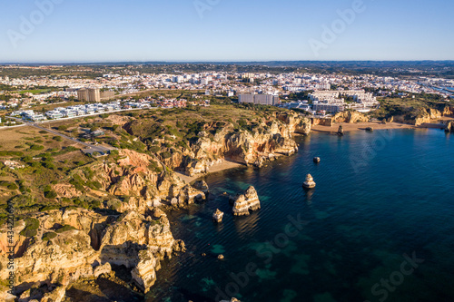 Ponta da Piedade lighthouse. Portuguese southern golden coast cliffs. Aerial view over city of Lagos in Algarve, Portugal.