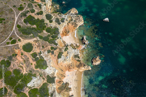 Camilo Beach in Lagos, Algarve - Portugal. Portuguese southern golden coast cliffs. Sunny day aerial view