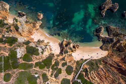 Camilo Beach in Lagos, Algarve - Portugal. Portuguese southern golden coast cliffs. Sunny day aerial view