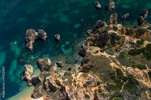 Camilo Beach in Lagos, Algarve - Portugal. Portuguese southern golden coast cliffs. Sunny day aerial view