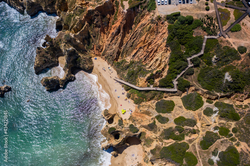 Camilo Beach in Lagos, Algarve - Portugal. Portuguese southern golden coast cliffs. Sunny day aerial view