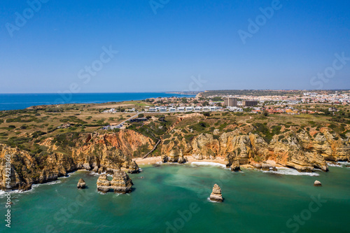 Camilo Beach in Lagos, Algarve - Portugal. Portuguese southern golden coast cliffs. Sunny day aerial view
