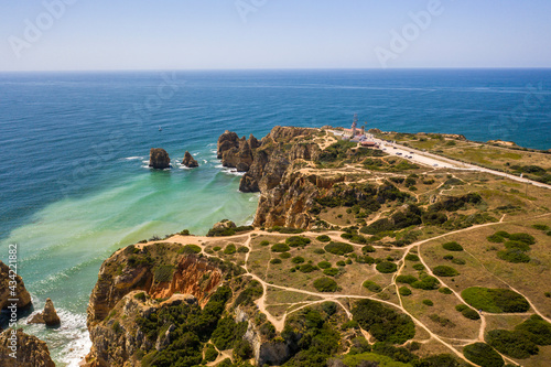 Aerial view of golden coast cliffs of portuguese southern beaches in Lagos City, Algarve, Portugal. Camilo beach and Ponta da Piedade.