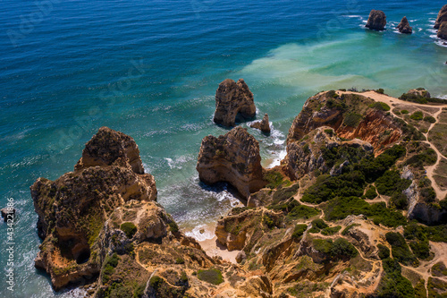 Camilo Beach in Lagos, Algarve - Portugal. Portuguese southern golden coast cliffs. Sunny day aerial view