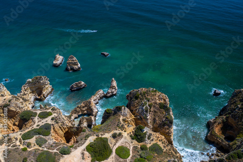 Aerial view of golden coast cliffs of portuguese southern beaches in Lagos City, Algarve, Portugal. Camilo beach and Ponta da Piedade.