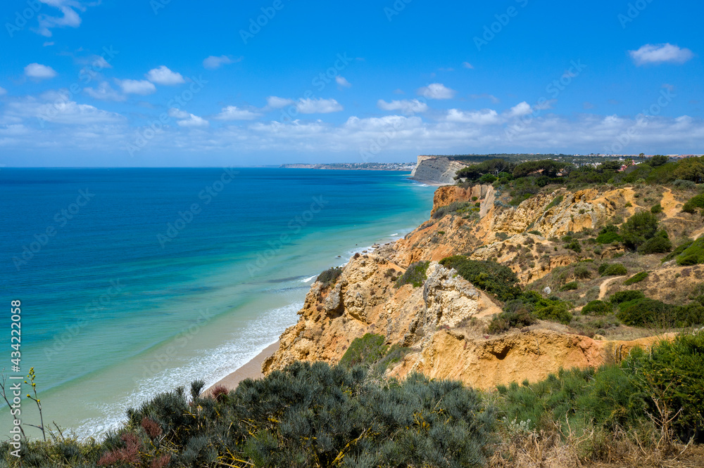 Canavial Beach in Lagos, Algarve - Portugal. Portuguese southern golden coast cliffs. Aerial view with sunny day. Canavial Beach in Lagos, Algarve - Portugal. Portuguese southern golden coast cliffs. Aerial view with sunny day.