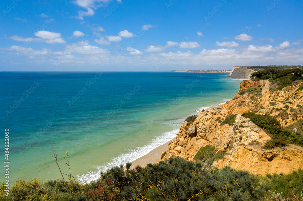 Canavial Beach in Lagos, Algarve - Portugal. Portuguese southern golden coast cliffs. Aerial view with sunny day.