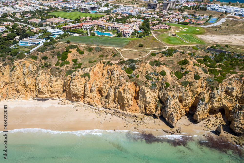 Canavial Beach. Portuguese southern golden coast cliffs. Aerial view over city of Lagos in Algarve, Portugal.