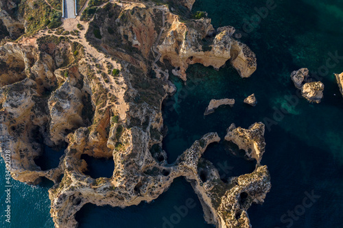 Ponta da Piedade lighthouse. Portuguese southern golden coast cliffs. Aerial view over city of Lagos in Algarve, Portugal.