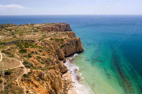 Canavial Beach in Lagos, Algarve - Portugal. Portuguese southern golden coast cliffs. Aerial view with sunny day.