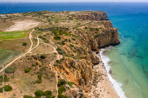 Canavial Beach in Lagos, Algarve - Portugal. Portuguese southern golden coast cliffs. Aerial view with sunny day.