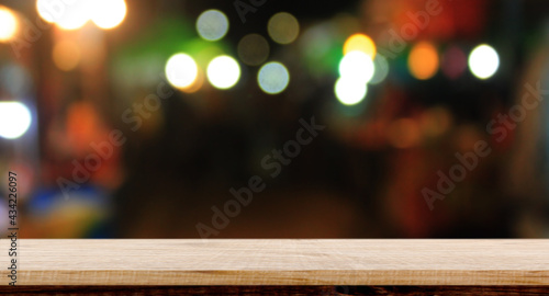 Empty wood table night street with bokeh background.