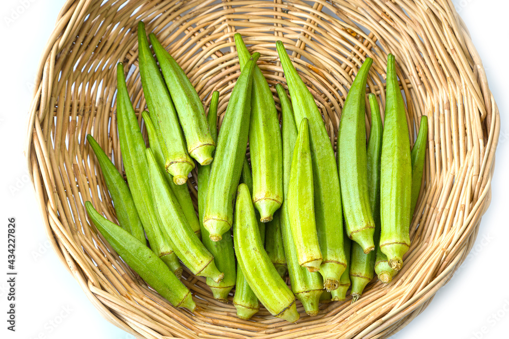 Fresh organic okra in wooden basket Fresh organic okra in wooden basket