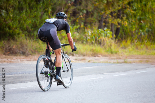 Professional cyclist during the cycling race. Shot in back - Image © PPstock