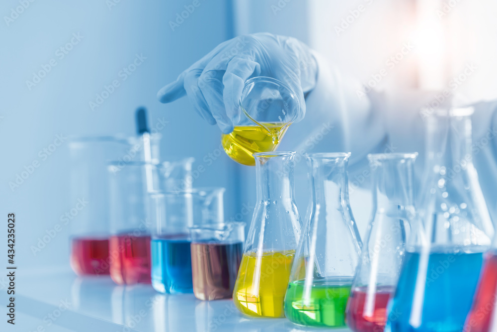 Close up test tube in laboratory analyzing scientist and doctor for research development pharmacy is treatment , healthcare and medical concept. Close up test tube in laboratory analyzing scientist and doctor for research development pharmacy is treatment , healthcare and medical concept.