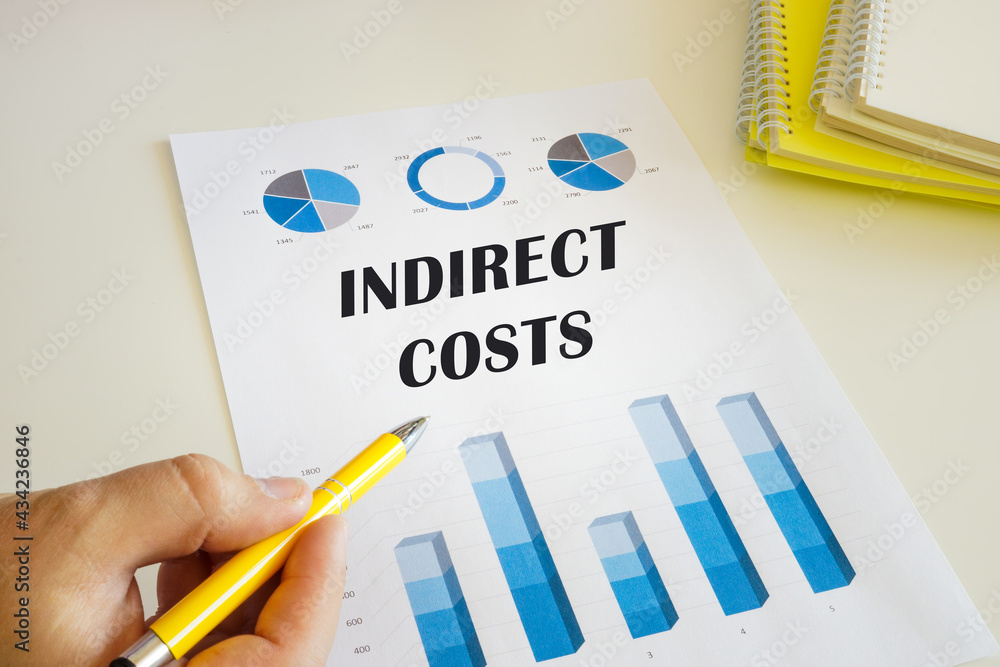 Accountant shows to the sign INDIRECT COSTS sign on the financial document. Accountant shows to the sign INDIRECT COSTS sign on the financial document.