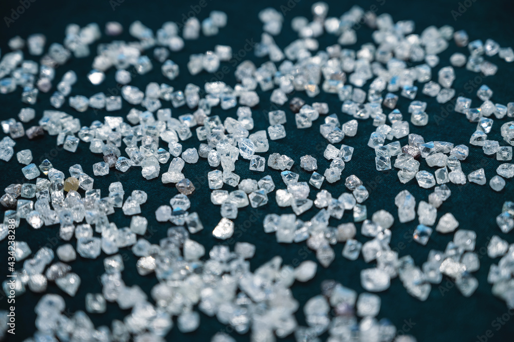 Close-up photo, a scattering of transparent diamonds on velvet