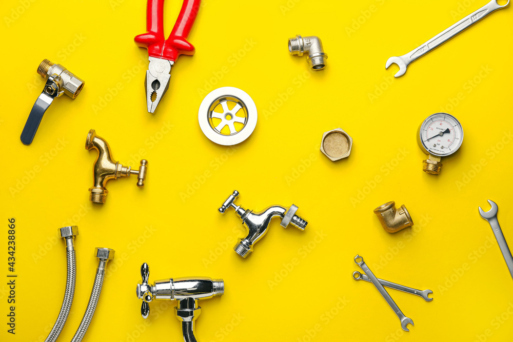 Fototapeta premium Set of plumber's items on color background