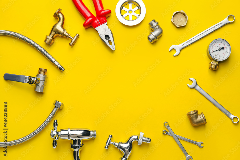 Frame made of plumber's items on color background Frame made of plumber's items on color background