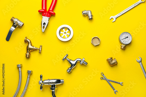 Set of plumber's items on color background