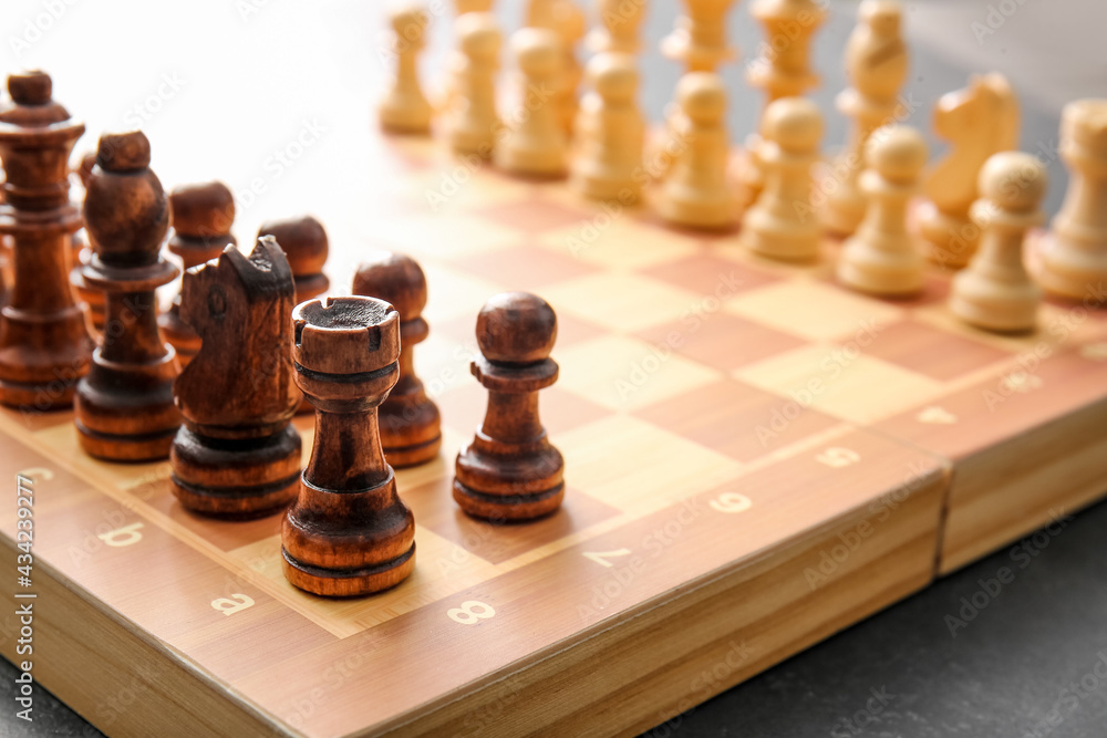 Game board with chess pieces on dark background Game board with chess pieces on dark background