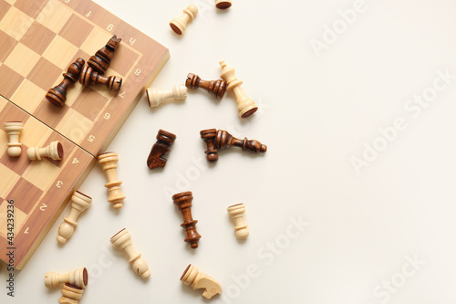 Game board with chess pieces on white background photo